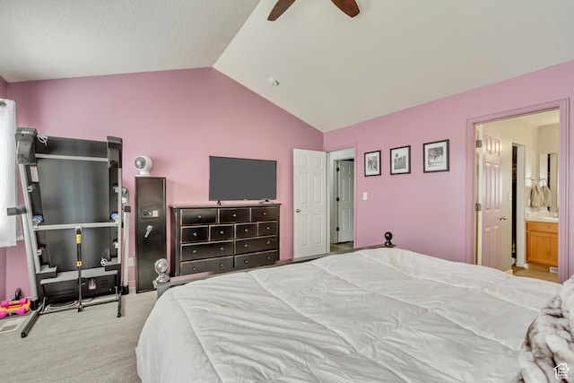 bedroom with ceiling fan, ensuite bath, lofted ceiling, and carpet floors