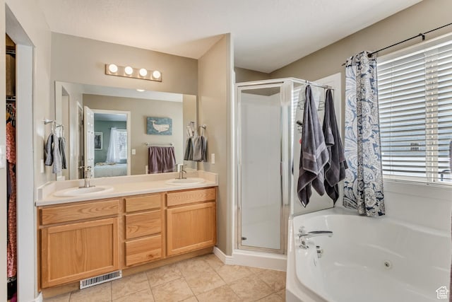 full bathroom with visible vents, connected bathroom, a shower stall, and a sink