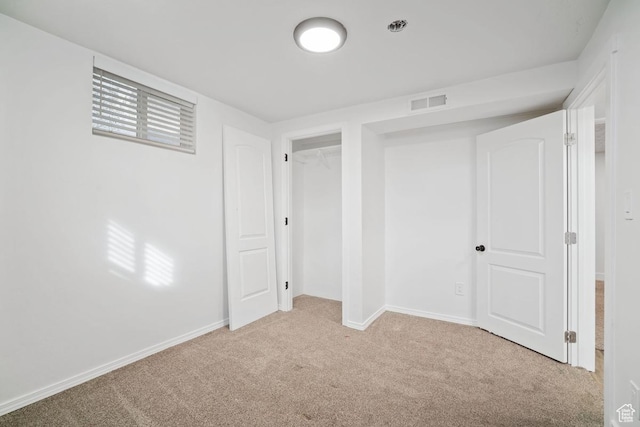 below grade area featuring carpet, visible vents, and baseboards