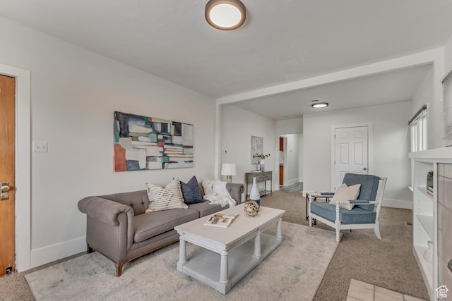living room with baseboards and light carpet