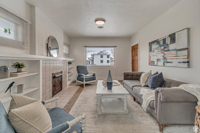 living area featuring baseboards and a fireplace