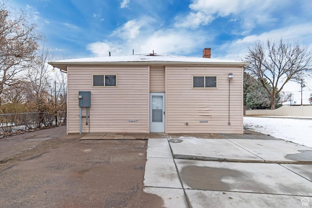 back of house with a chimney, fence, and a patio