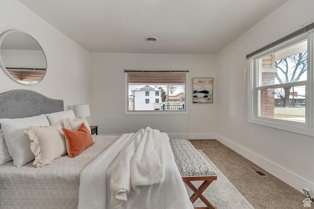 bedroom featuring carpet floors, baseboards, and visible vents
