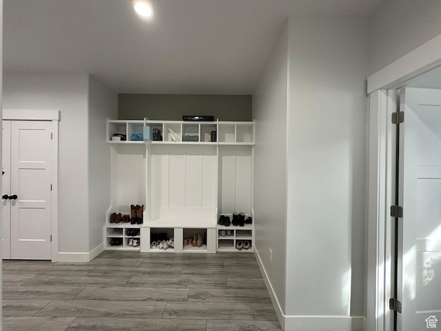 mudroom with wood finished floors and baseboards