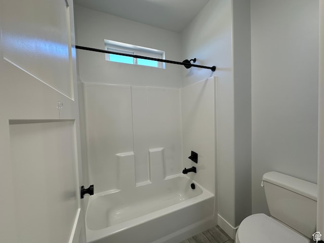 full bathroom featuring shower / tub combination, toilet, and baseboards