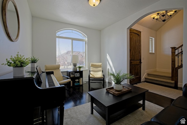 406 N 1420 E, Provo, UT 84606 - living room with baseboards, a chandelier, stairway, arched walkways, and wood finished floors