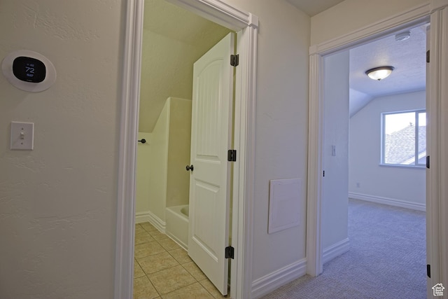 406 N 1420 E, Provo, UT 84606 - hallway featuring baseboards, vaulted ceiling, a textured wall, light tile patterned floors, and light colored carpet