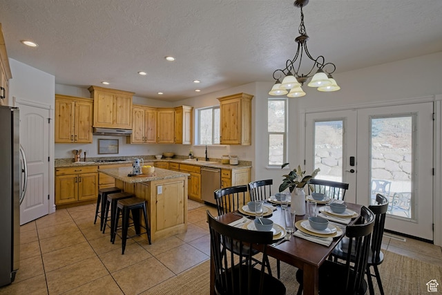 406 N 1420 E, Provo, UT 84606 - kitchen with a center island, a sink, under cabinet range hood, stainless steel appliances, and a breakfast bar area