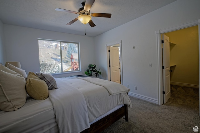 406 N 1420 E, Provo, UT 84606 - carpeted bedroom with a textured ceiling, ceiling fan, baseboards, and a walk in closet