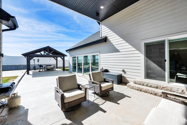 view of patio featuring a gazebo, outdoor dining area, and an outdoor living space