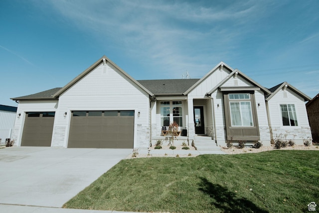 417 E 1460 S Unit 48, Salem, UT 84653 - view of front of home with board and batten siding, a front lawn, driveway, stone siding, and an attached garage