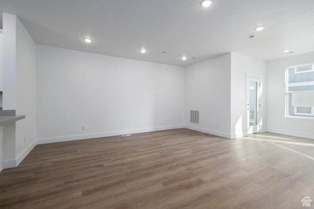 interior space featuring recessed lighting, wood finished floors, and visible vents