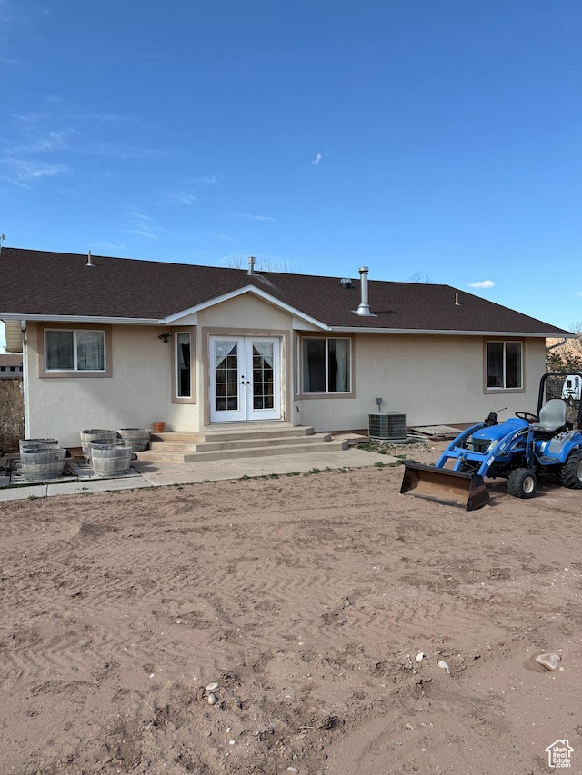 4710 Luna Cir, Moab, UT 84532 - back of house with stucco siding, entry steps, central AC unit, and french doors