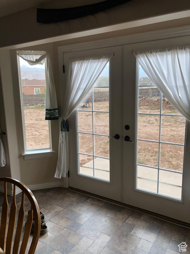 4710 Luna Cir, Moab, UT 84532 - doorway to outside with stone finish floor, french doors, and baseboards