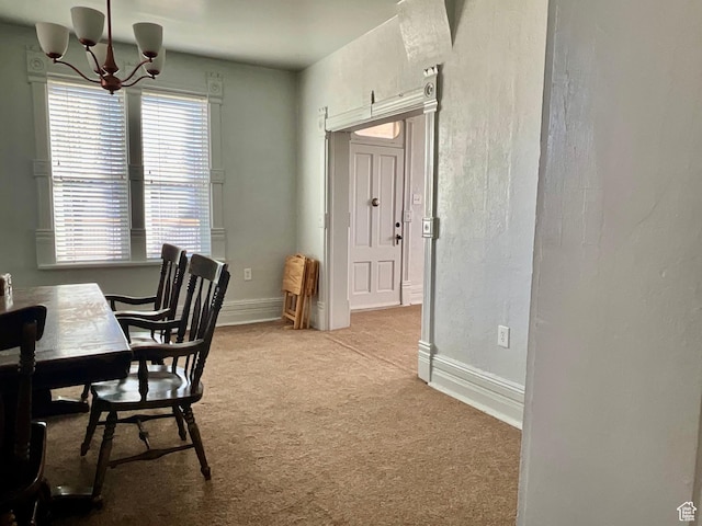 office space featuring baseboards, carpet floors, and a notable chandelier