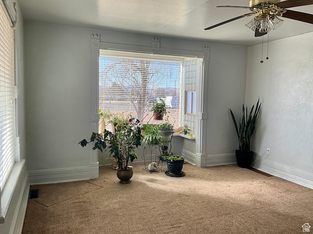 sitting room with ceiling fan, baseboards, and carpet