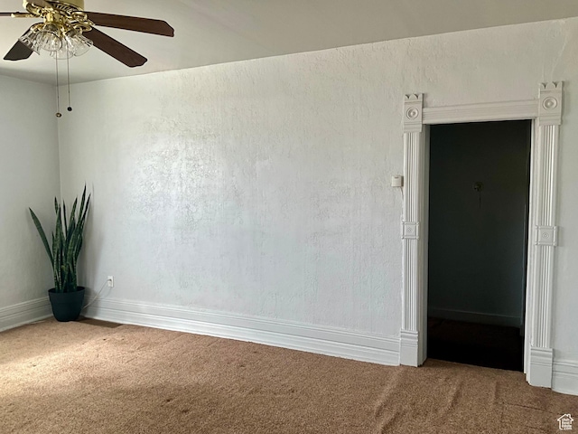 spare room with carpet and ceiling fan