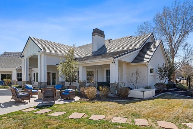 2917 S Old Farm Rd, Washington, UT 84780 - back of house with a patio area, a chimney, an outdoor living space, and a yard