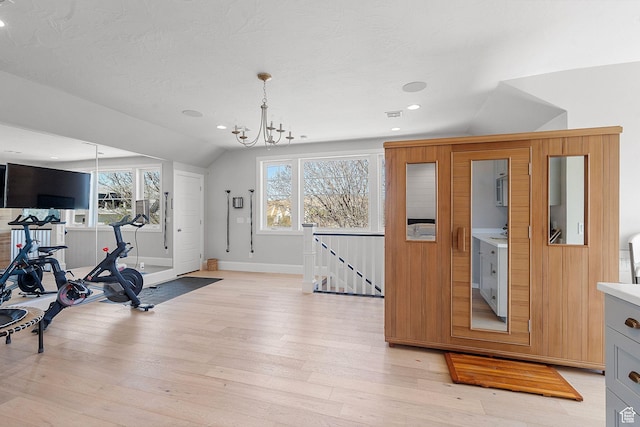 2917 S Old Farm Rd, Washington, UT 84780 - workout room featuring vaulted ceiling, baseboards, an inviting chandelier, and light wood-style floors