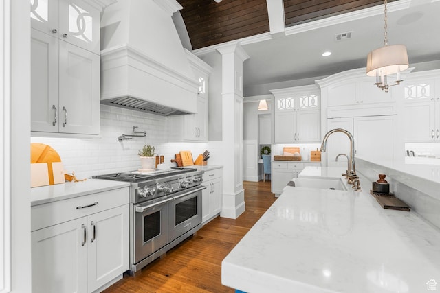2917 S Old Farm Rd, Washington, UT 84780 - kitchen with range with two ovens, visible vents, a sink, decorative columns, and custom exhaust hood