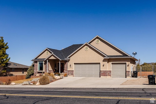 841 E Nichols Canyon Rd, Cedar City, UT 84721 - craftsman-style house with fence, stucco siding, concrete driveway, a garage, and brick siding