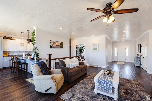 841 E Nichols Canyon Rd, Cedar City, UT 84721 - living area featuring a textured ceiling, visible vents, dark wood-style flooring, and ornamental molding