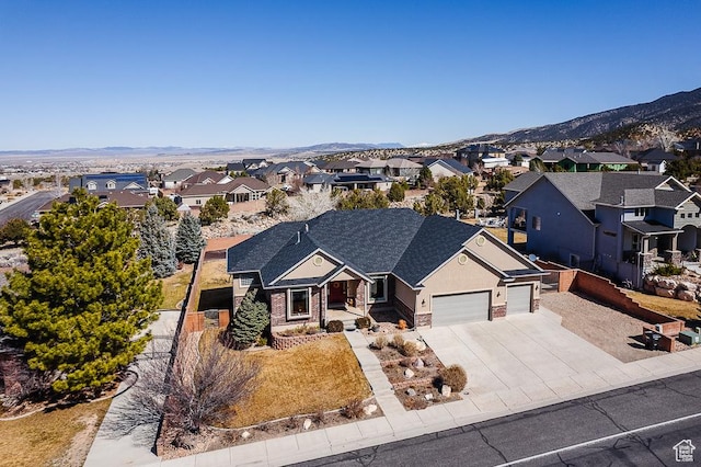 841 E Nichols Canyon Rd, Cedar City, UT 84721 - view of front of house with an attached garage, a shingled roof, a residential view, concrete driveway, and a mountain view
