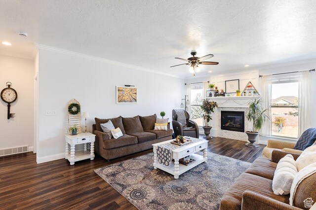 841 E Nichols Canyon Rd, Cedar City, UT 84721 - living area featuring dark wood finished floors, a glass covered fireplace, visible vents, and a textured ceiling