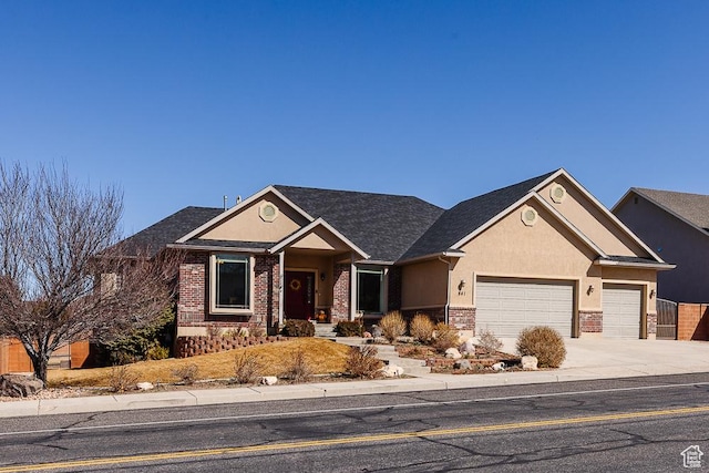 841 E Nichols Canyon Rd, Cedar City, UT 84721 - view of front facade featuring stone siding, stucco siding, concrete driveway, and a garage
