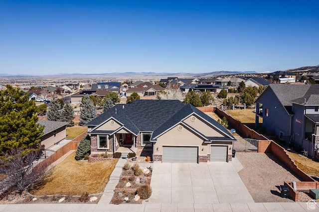 841 E Nichols Canyon Rd, Cedar City, UT 84721 - view of front of property featuring fence, a residential view, stucco siding, stone siding, and driveway