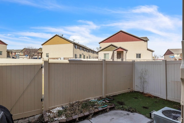 1273 N Baycrest Dr, Saratoga Springs, UT 84045 - view of yard featuring central AC unit, a gate, a fenced backyard, and a residential view