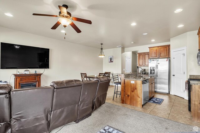 1273 N Baycrest Dr, Saratoga Springs, UT 84045 - living area with light tile patterned floors, a fireplace, ceiling fan, and recessed lighting