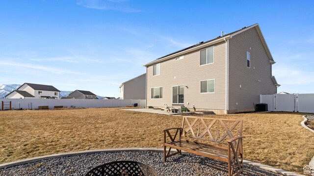 1474 E 480 S, Hyrum, UT 84319 - rear view of house with a gate, a patio, central AC, a fenced backyard, and a yard