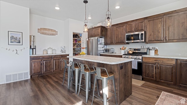 1474 E 480 S, Hyrum, UT 84319 - kitchen featuring visible vents, a center island, light countertops, appliances with stainless steel finishes, and dark wood-style flooring