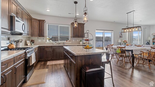 1474 E 480 S, Hyrum, UT 84319 - kitchen with dark wood-type flooring, a sink, a center island, stainless steel appliances, and light countertops
