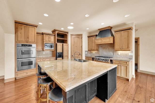 kitchen featuring open shelves, a sink, built in appliances, premium range hood, and baseboards