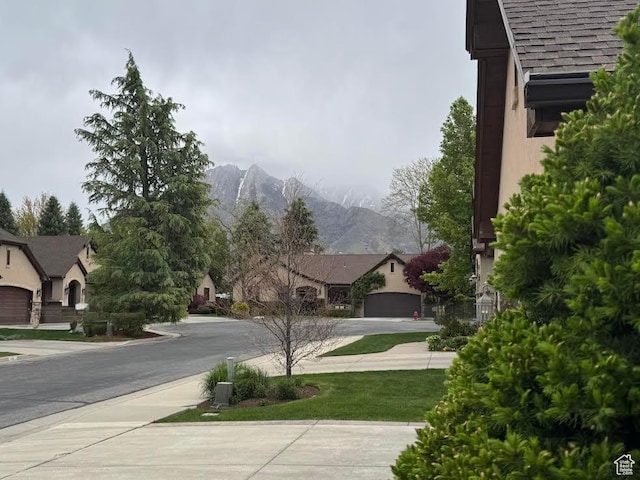 view of street featuring sidewalks and a mountain view