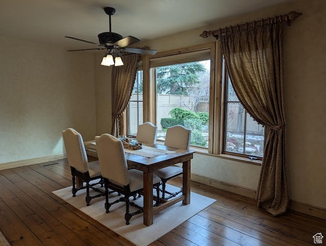 dining space featuring a wealth of natural light, hardwood / wood-style flooring, and baseboards