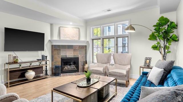 131 W Village Ln, Provo, UT 84604 - living area featuring visible vents, a fireplace, wood finished floors, and ornamental molding