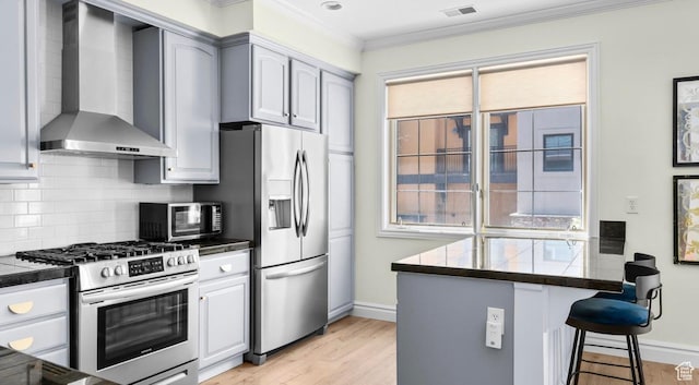 131 W Village Ln, Provo, UT 84604 - kitchen with wall chimney range hood, a breakfast bar, ornamental molding, decorative backsplash, and appliances with stainless steel finishes
