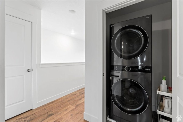 10757 S Lamond Dr, South Jordan, UT 84009 - washroom featuring stacked washing machine and dryer, wood finished floors, and baseboards