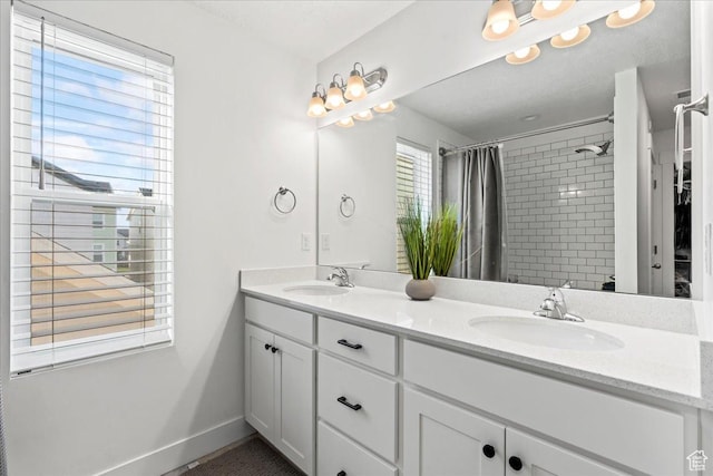 10757 S Lamond Dr, South Jordan, UT 84009 - bathroom with tiled shower, double vanity, and baseboards