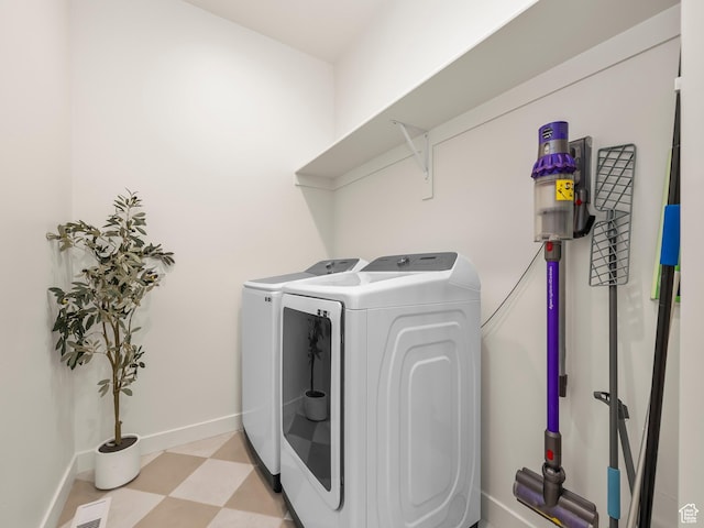clothes washing area featuring visible vents, washer and clothes dryer, baseboards, light floors, and laundry area