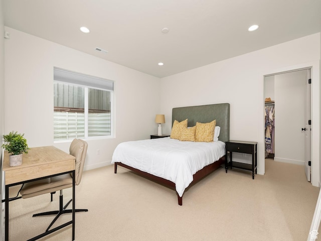 bedroom featuring a spacious closet, recessed lighting, light colored carpet, and baseboards