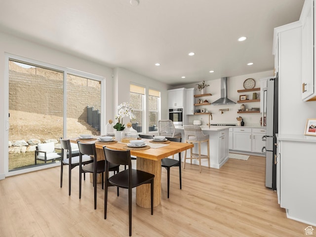 dining space featuring recessed lighting and light wood-style flooring