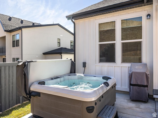 view of patio / terrace featuring fence, area for grilling, and a hot tub