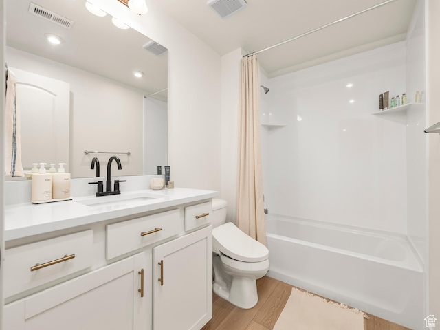 full bath with visible vents, shower / bath combo with shower curtain, toilet, and wood finished floors