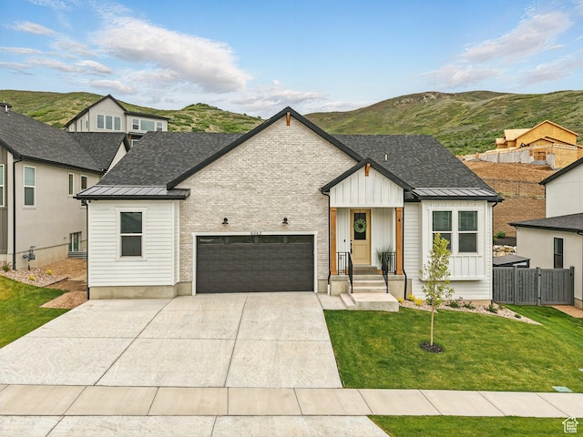 6062 N Fox Canyon Rd, Lehi, UT 84043 - modern farmhouse style home with a standing seam roof, a garage, metal roof, a mountain view, and concrete driveway