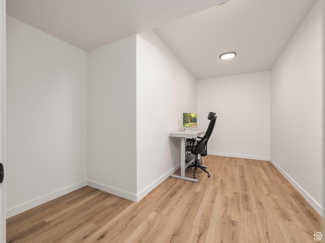 office space with baseboards and wood finished floors