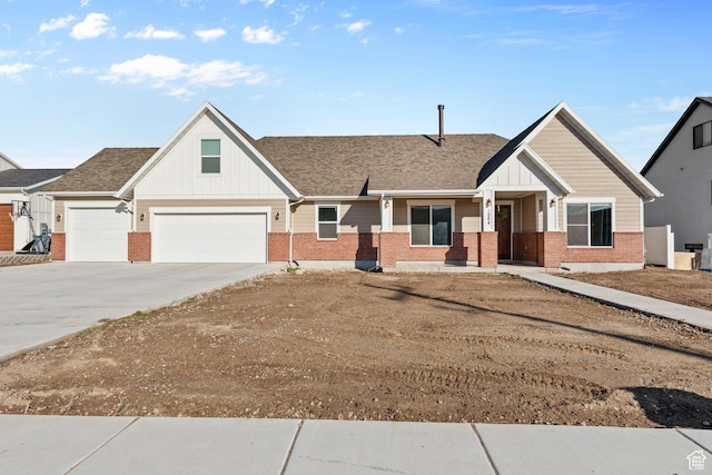 1984 S 4300 W, Ogden, UT 84401 - view of front of home with roof with shingles, board and batten siding, concrete driveway, and brick siding